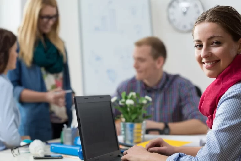 Portait of smiling young intern at office