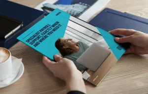 Person holding a physical copy of the Zellis payroll assistance services brochure